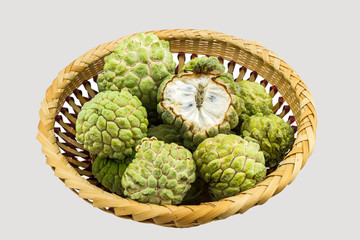 Close up ripe Custard apple in bamboo basket isolated on white background.Saved with clipping path.
