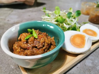 Crab Chili Paste in mini green cup with Boiled Eggs , Vegetable on wooden plate