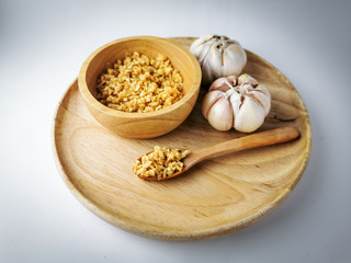 Fresh garlic in a wooden tray, Fried garlic wooden spoon and wooden cup 