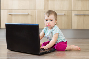 small child plays on computer. The child Prodigy learns the techniques of business Planning, home work, quarantine, self-isolation, protection from coronavirus, virus. Ordering products over Internet 