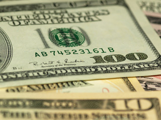 Colorful background with money US dollars of different value. Top view of business concept with finance for banks. American banknotes 5, 10, 50, 100 dollars backdrop