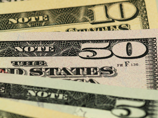 Colorful background with money US dollars of different value. Top view of business concept with finance for banks. American banknotes 5, 10, 50, 100 dollars backdrop