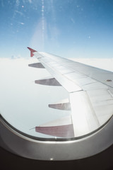 Fototapeta premium View of beautiful cloud and wing of airplane from window