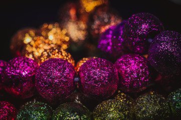 
multicolored christmas beads with boke in the background