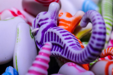 multicolored curly beads in the shape of a seahorse and shell