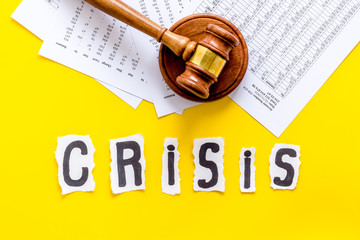 Financial crisis concept with gavel - debt, bankruptcy - on yellow background top view