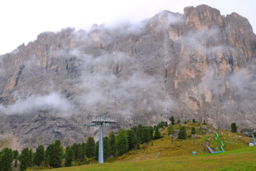 The peaks of the Dolomites in Italy are covered in fog. Selective focus.