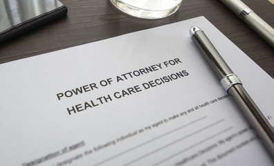 A power of attorney on the table. A document on the desk.  power of attorney for health care. - obrazy, fototapety, plakaty