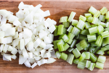plant-based food, chopped onions and celeri on cutting board with knife