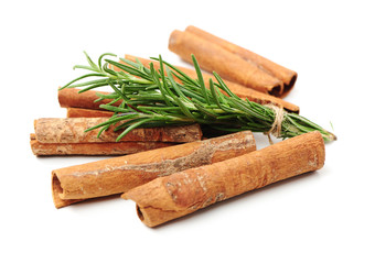 Cinnamon and rosemary on a white background