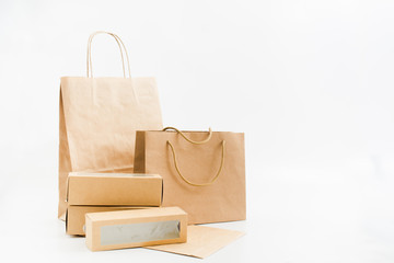 Recyclable paper bags and boxes on white background. Shopping concept