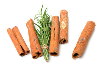 Cinnamon and rosemary on a white background