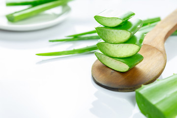 Aloe Vera sliced on wood spoon isolated on white background.