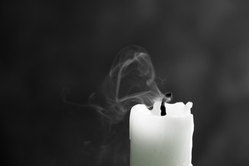 extinct white candle with spectacular, abstract smoke on a black background, black and white photo,...