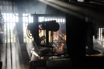 Old fashioned coffee factory full of smoke and aroma of roasted coffee still favorite among local consumers.   