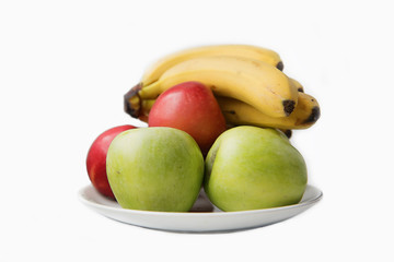fruit apples and bananas on a white plate