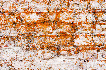 Texture of a brick wall with cracks and scratches which can be used as a background