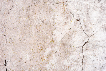 Texture of a concrete wall with cracks and scratches which can be used as a background