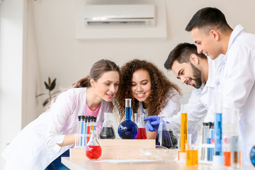 Young people at chemistry lesson in classroom