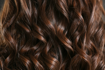 Healthy curly female hair, closeup