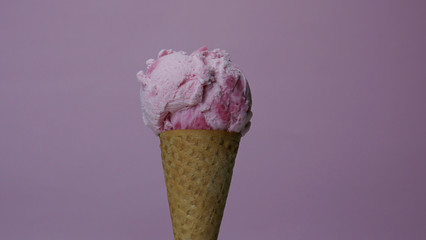 Strawberry Ice Cream Cone on pink background, Front view Food concept.