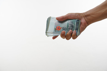 Malay hand holding Malaysia ringgit on white background. 