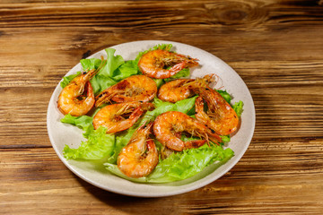 Tasty baked shrimps on a wooden table