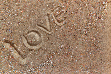 inscription love in the sand, close-up
