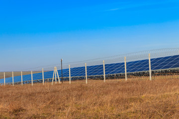 Fototapeta premium Rows of solar panels in solar power plant. Photovoltaic modules for innovation alternative energy