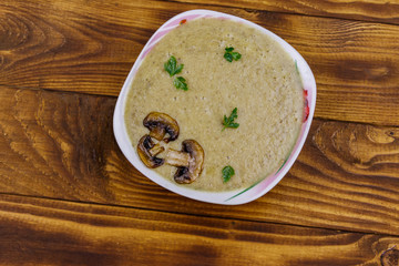Mushroom cream soup on a wooden table. Top view