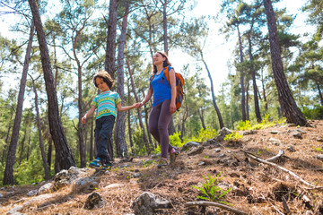 A child with his mother go hiking.