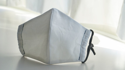 Close-up photo of a handmade white mask