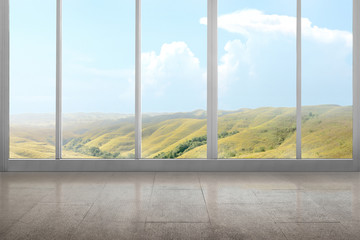 Empty room with green hills view