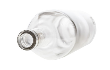 overturned empty clear bottle isolated on white background