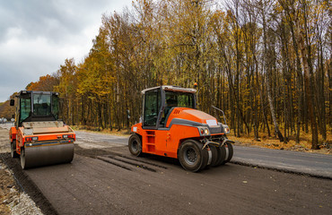Large view on the road rollers working on the new road construction site. Selective focus on road repairing, Closeup