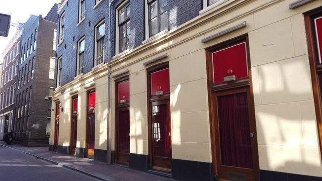 Slow pan of multiple windows in the red-light district lockdown during the Coronavirus pandemic in Amsterdam