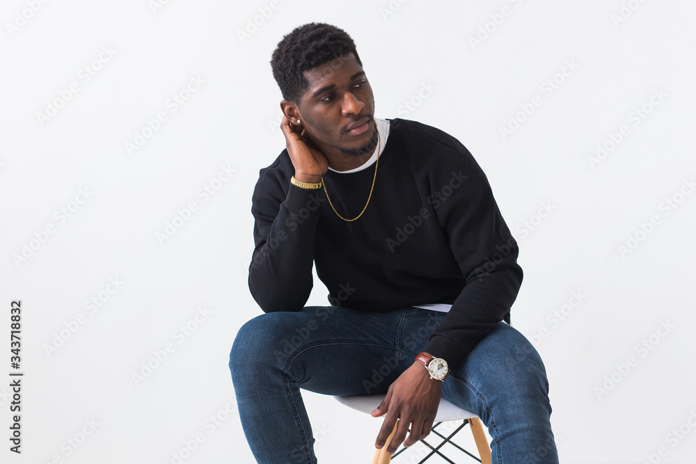 Wall mural Youth street fashion concept - Portrait of confident sexy black man in stylish sweatshirt on white background. - Wall murals