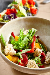 Salmon fillet salad in clay plate