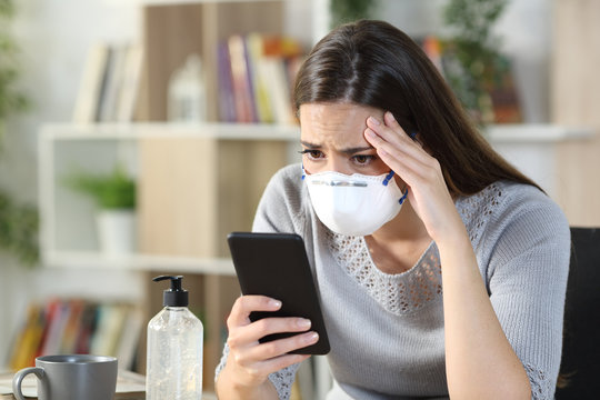 Worried Girl Reading Bad Coronavirus News On Phone At Home