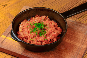 Vegetable and meat stew served in a pan over rustic wooden background table. Ukranian Traditional cuisine.