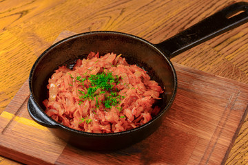 Vegetable and meat stew served in a pan over rustic wooden background table. Ukranian Traditional cuisine.