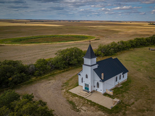 Beautiful white Chapel church in the middle of nowhere at the side of a small remote  village drone photography 