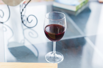 Glass of red wine on table close up, top view. Alcohol and drinks concept.