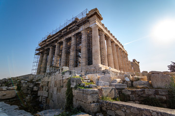 Fototapeta premium Side view of the facade of the Partenon in Athens surrounded by scaffolding during its reconstruction and rehabilitation works, Greece