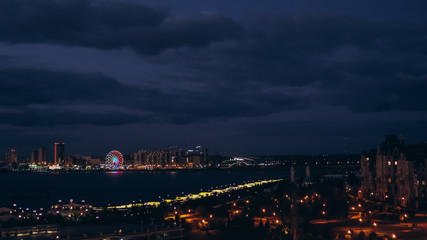 Fototapeta na wymiar Russia. Kazan. August, 2019. Summer. View of the night coast of Kazan. Ferris wheel. City center