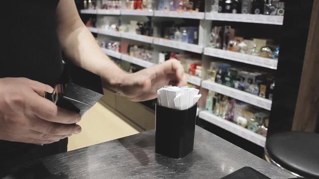 A young man in a duty free shop chooses a fragrance that he will like
