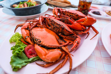 Many bright red steamed sea crabs Lined in a plate ready to serve for those who like to eat seafood, Chanthaburi, Thailand.