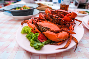 Many bright red steamed sea crabs Lined in a plate ready to serve for those who like to eat seafood, Chanthaburi, Thailand.