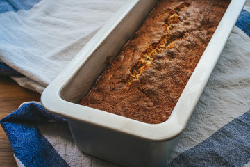 cake in an oblong shape on a beautiful towel and a wooden table