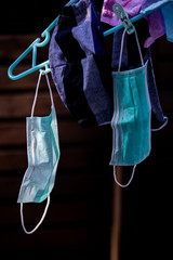 Surgical mask prepared to reuse by hanging in sunlight for drying after washing Portrait position, Covid-19